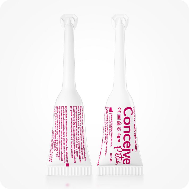 Conceive Plus Fertility Lubricant (8x4g Pre-filled Applicators) close-up of two single-use applicators, one showing front label with branding and dosage, and other displaying back text instructions in fine pink print, both standing upright on a clean white background.